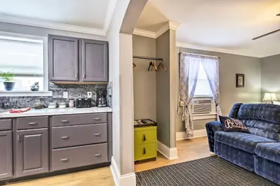 a kitchen and living room with a blue couch at Modern Studio Apartment in Central Williamstown! in Williamstown