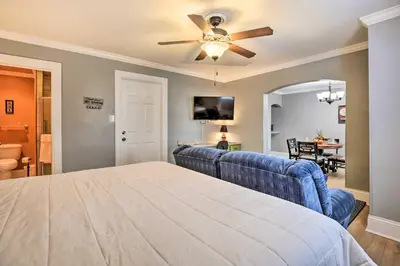 a bedroom with a blue couch and a ceiling fan at Modern Studio Apartment in Central Williamstown! in Williamstown