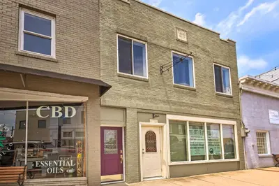 a brick building with a cdd store on a street at Modern Studio Apartment in Central Williamstown! in Williamstown