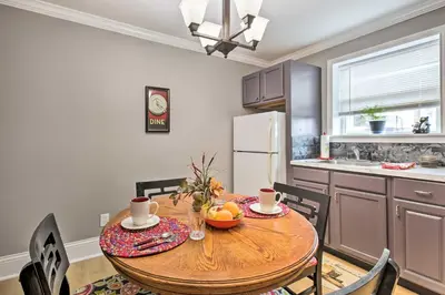 a kitchen with a wooden table with chairs and a dining room at Modern Studio Apartment in Central Williamstown! in Williamstown