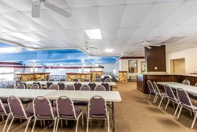 a conference room with white tables and purple chairs at Wingate by Wyndham Marietta Conference Center Ohio in Marietta