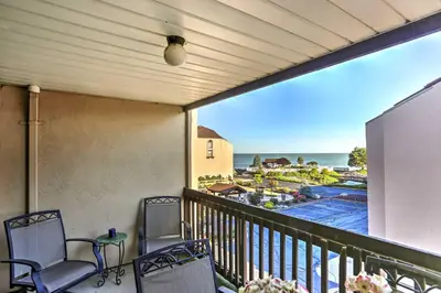 a balcony with chairs and a view of the ocean at Waterfront Port Clinton Condo with Pool Access! in Port Clinton