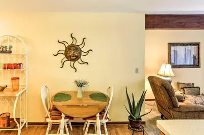 a dining room with a table with a sun on the wall at Waterfront Port Clinton Condo with Pool Access! in Port Clinton
