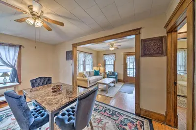 a dining room and living room with a table and chairs at Charming Urbana Home Near Downtown! in Urbana