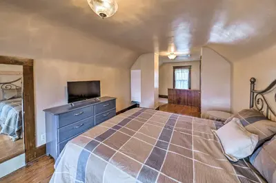 a bedroom with a large bed and a television at Charming Urbana Home Near Downtown! in Urbana