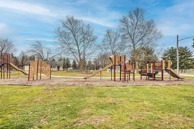 a playground with a slide in a park at Charming Urbana Home Near Downtown! in Urbana