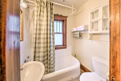 a bathroom with a tub and a toilet and a sink at Charming Urbana Home Near Downtown! in Urbana