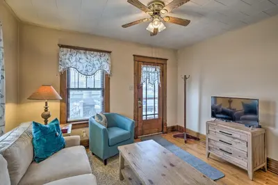 a living room with a couch and a tv at Charming Urbana Home Near Downtown! in Urbana
