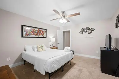 a bedroom with a bed and a ceiling fan at 4BR, 3Bath for 11, Near Ark, Plenty of Free Parking in Williamstown