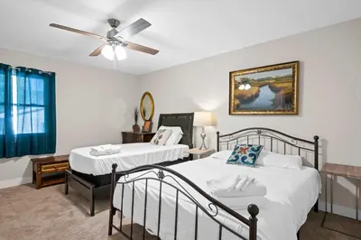 a bedroom with two beds and a ceiling fan at 4BR, 3Bath for 11, Near Ark, Plenty of Free Parking in Williamstown