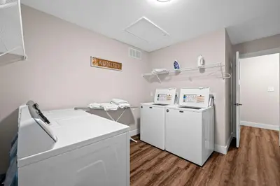 a laundry room with two washer and dryer at 4BR, 3Bath for 11, Near Ark, Plenty of Free Parking in Williamstown