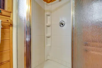 a shower with a glass door in a bathroom at Hocking Hills Lake Gem with Hot Tub, Dock, 100 Acres in Hamden