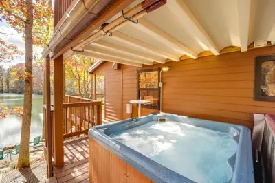 a hot tub on the deck of a house at Hocking Hills Lake Gem with Hot Tub, Dock, 100 Acres in Hamden