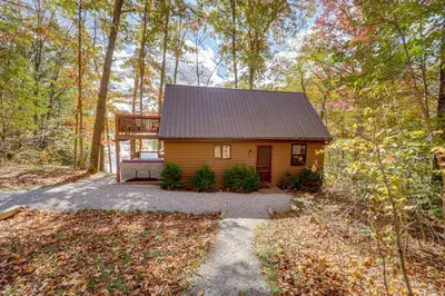 a tiny house in the woods with a porch at Hocking Hills Lake Gem with Hot Tub, Dock, 100 Acres in Hamden