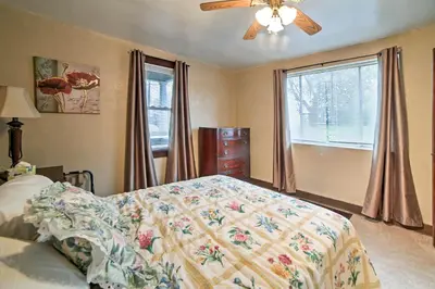 a bedroom with a bed and a ceiling fan at Burgettstown Home - 7 Mi to KeyBank Pavilion in Burgettstown