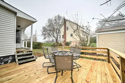 a wooden deck with a table and chairs on it at Burgettstown Home - 7 Mi to KeyBank Pavilion in Burgettstown