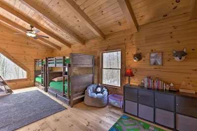 a bedroom with two bunk beds in a cabin at Family-Friendly Warsaw Cabin with Deck and Fireplace! in Warsaw