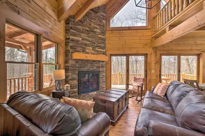 a living room with leather furniture and a fireplace at Family-Friendly Warsaw Cabin with Deck and Fireplace! in Warsaw