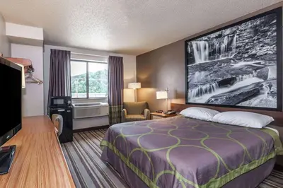 a hotel room with a bed and a window at Super 8 by Wyndham Dunbar/Charleston Area in Charleston