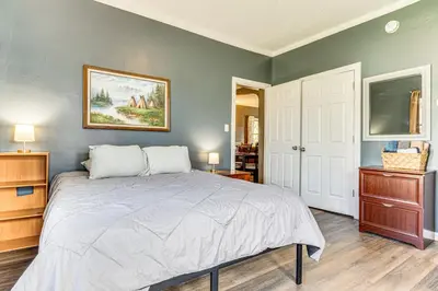 a bedroom with a bed and a painting on the wall at The Junction Victorian Home in Quaint Fortville! in Fortville