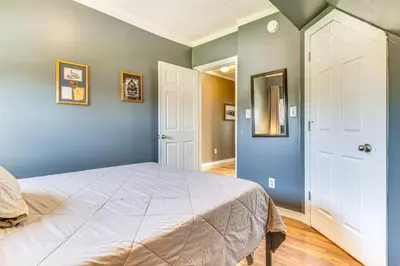 a bedroom with a large bed with blue walls at The Junction Victorian Home in Quaint Fortville! in Fortville