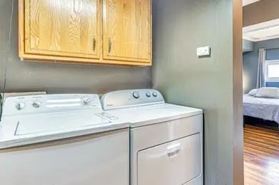 a washer and dryer in a small laundry room at The Junction Victorian Home in Quaint Fortville! in Fortville