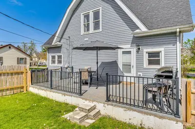 a patio with an umbrella and a table and chairs at The Junction Victorian Home in Quaint Fortville! in Fortville