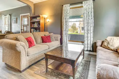 a living room with a couch and a coffee table at The Junction Victorian Home in Quaint Fortville! in Fortville