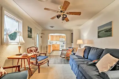 a living room with a blue couch and a ceiling fan at Ottawa Lake Home with BBQ and Patio, 15 Mi to Toledo in Sylvania