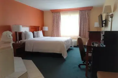 a hotel room with a bed and a window at Buckeye Inn Express in Columbus