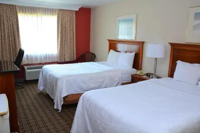 a hotel room with two beds and a window at Buckeye Inn Express in Columbus