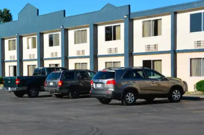 three cars parked in a parking lot in front of a building at Buckeye Inn Express in Columbus