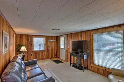 a living room with a couch and a flat screen tv at Home with Lake-View Deck by Camp Perry and Magee Marsh in Port Clinton