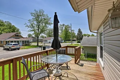 a patio with a table and an umbrella on a deck at Home with Lake-View Deck by Camp Perry and Magee Marsh in Port Clinton