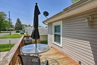a glass table and an umbrella on a deck at Home with Lake-View Deck by Camp Perry and Magee Marsh in Port Clinton