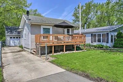 a house with a wooden deck in the yard at Home with Lake-View Deck by Camp Perry and Magee Marsh in Port Clinton