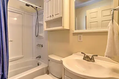 a bathroom with a sink and a toilet and a mirror at Home with Lake-View Deck by Camp Perry and Magee Marsh in Port Clinton