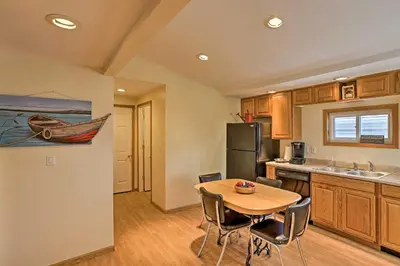 a kitchen with a wooden table and a kitchen with a tablektop at Home with Lake-View Deck by Camp Perry and Magee Marsh in Port Clinton
