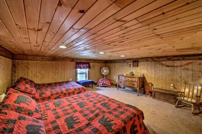 a bedroom with a bed and a wooden ceiling at The Bovard Lodge Rustic Cabin Near Ohio River! in Florence