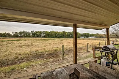 a view of a field from the back porch of a house at The Bovard Lodge Rustic Cabin Near Ohio River! in Florence