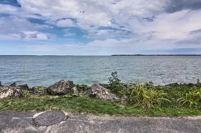 a manhole cover in front of a body of water at Spacious Lakeside Cottage - 2 Miles to Marblehead! in Lakeside