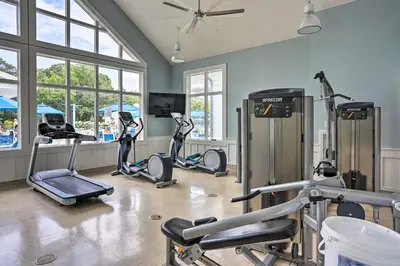 a gym with several exercise bikes in a room with windows at Spacious Lakeside Cottage - 2 Miles to Marblehead! in Lakeside