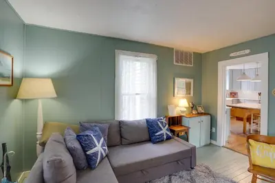 a living room with a couch and a kitchen at Spacious Lakeside Cottage - 2 Miles to Marblehead! in Lakeside