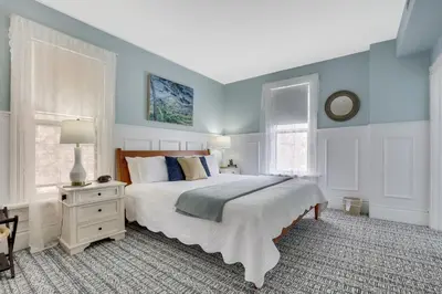 a bedroom with a large bed with blue walls at 50 Lincoln Short North Bed & Breakfast in Columbus