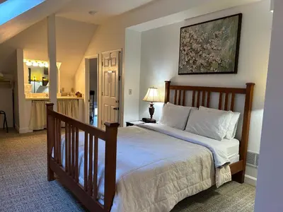 a bedroom with a large bed with a picture on the wall at 50 Lincoln Short North Bed & Breakfast in Columbus