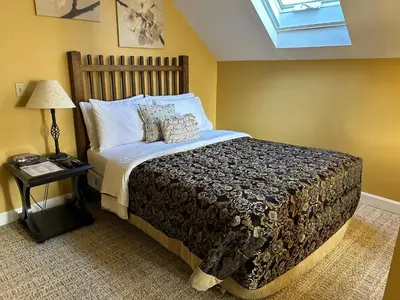 a bedroom with a large bed and a window at 50 Lincoln Short North Bed & Breakfast in Columbus