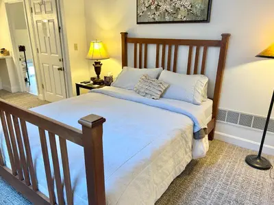 a bedroom with a large bed with a wooden frame at 50 Lincoln Short North Bed & Breakfast in Columbus