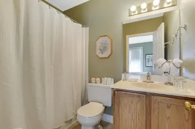 a bathroom with a toilet and a sink and a mirror at 50 Lincoln Short North Bed & Breakfast in Columbus
