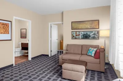 a living room with a couch and a chair at TownePlace Suites Cincinnati Fairfield in Fairfield
