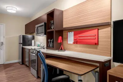 a small kitchen with a desk and a microwave at TownePlace Suites Cincinnati Fairfield in Fairfield